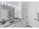 Bathroom featuring a granite vanity top, shower, and white cabinets at 4407 Lake Trudy Dr, St Cloud, FL 34769