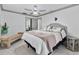 Light and bright bedroom features a ceiling fan, tile floors, a bench, and neutral tones at 4407 Lake Trudy Dr, St Cloud, FL 34769