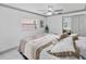 Light and bright bedroom features a ceiling fan, tile floors, a bench, and neutral tones at 4407 Lake Trudy Dr, St Cloud, FL 34769