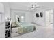 Bright bedroom features tile floors, a ceiling fan, a flatscreen tv, and access to the backyard at 4407 Lake Trudy Dr, St Cloud, FL 34769