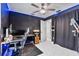 Bedroom featuring a dark accent wall, desk setup, and ceiling fan with LED lighting at 4407 Lake Trudy Dr, St Cloud, FL 34769