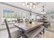 Dining room featuring a wood table, chairs, and natural light from large windows at 4407 Lake Trudy Dr, St Cloud, FL 34769