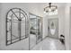 Foyer featuring stylish tile flooring, front door, and contemporary mirror at 4407 Lake Trudy Dr, St Cloud, FL 34769