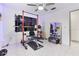 Home gym featuring weight rack, workout bench, mirror and tile floors at 4407 Lake Trudy Dr, St Cloud, FL 34769