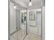 Bright hallway with mirror closet doors and tiled floors provides elegant access to other rooms at 4407 Lake Trudy Dr, St Cloud, FL 34769