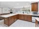 Bright kitchen featuring wood cabinets, white counters, tile floors and modern appliances at 4407 Lake Trudy Dr, St Cloud, FL 34769