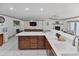 Open floor plan with kitchen island, wood cabinets, and adjacent living area at 4407 Lake Trudy Dr, St Cloud, FL 34769