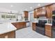 Well-appointed kitchen with an island, white countertops, and dark wood cabinetry at 4407 Lake Trudy Dr, St Cloud, FL 34769