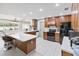 Well-equipped kitchen featuring an island, white countertops, and dark wood cabinetry at 4407 Lake Trudy Dr, St Cloud, FL 34769