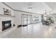 Open-concept living and dining area with fireplace, tile flooring and sliding doors at 4407 Lake Trudy Dr, St Cloud, FL 34769