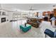 Open-concept living area with tile floors, a fireplace, and seamless access to the kitchen and dining at 4407 Lake Trudy Dr, St Cloud, FL 34769