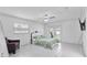 Bright primary bedroom featuring a ceiling fan, white walls, tile floors and french doors at 4407 Lake Trudy Dr, St Cloud, FL 34769
