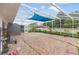 Large outdoor tiled patio with sunshade, leading to the backyard and offering space for outdoor living at 4407 Lake Trudy Dr, St Cloud, FL 34769