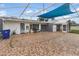 Spacious outdoor tiled patio, partially covered, with plants, shed, and access to the backyard at 4407 Lake Trudy Dr, St Cloud, FL 34769