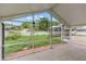 Spacious screened patio view of the backyard with well-maintained landscaping, trees, and white fence at 4407 Lake Trudy Dr, St Cloud, FL 34769