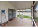 Enclosed back porch featuring tile flooring, screen walls, and a rear door at 4407 Lake Trudy Dr, St Cloud, FL 34769