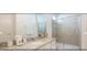 Bathroom with granite countertops, dual vanity sinks, and glass enclosed shower at 4504 Monado Dr, Kissimmee, FL 34746
