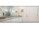 Bathroom featuring granite countertops, vanity, and enclosed glass shower with decorative flower arrangement at 4504 Monado Dr, Kissimmee, FL 34746