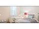Bright bedroom featuring two beds, a nightstand, and nautical accents at 4504 Monado Dr, Kissimmee, FL 34746