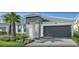 Lovely home featuring an attached garage, paver driveway, well-maintained lawn and pretty landscaping at 4504 Monado Dr, Kissimmee, FL 34746