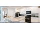 Modern kitchen with granite counters, stainless steel appliances, an island with bar seating, and white cabinets at 4504 Monado Dr, Kissimmee, FL 34746