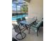 Patio with table, seating, and relaxing poolside views of the lake at 4504 Monado Dr, Kissimmee, FL 34746