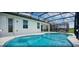 Gorgeous screened-in pool with an outdoor seating area, ideal for entertaining guests at 4504 Monado Dr, Kissimmee, FL 34746