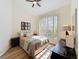 Bright bedroom with a large window, a ceiling fan, and a dresser at 458 Moscato Dr, Davenport, FL 33897