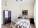 Bright bedroom featuring a wardrobe, queen bed, and a sun-filled window at 458 Moscato Dr, Davenport, FL 33897