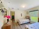 Bright bedroom with two beds, storage, and laminate wood floors at 458 Moscato Dr, Davenport, FL 33897