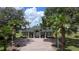 View of the community clubhouse framed by tall palm trees at 458 Moscato Dr, Davenport, FL 33897