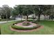 A tiered fountain is surrounded by manicured landscaping in this verdant community at 458 Moscato Dr, Davenport, FL 33897