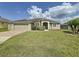 Single story home with landscaped front yard, brick driveway, and neutral color scheme at 458 Moscato Dr, Davenport, FL 33897