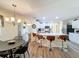 Modern kitchen with white cabinets, stainless steel appliances, and a breakfast bar with decorative pendant lighting at 458 Moscato Dr, Davenport, FL 33897