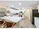 Modern kitchen with white cabinets, stainless steel appliances, breakfast bar and view to living room at 458 Moscato Dr, Davenport, FL 33897