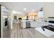 Well-lit kitchen featuring a large island, stainless steel appliances, and an open view to the living area at 458 Moscato Dr, Davenport, FL 33897