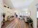 Bright living room with hardwood floors, neutral paint, vaulted ceilings, and modern decor at 458 Moscato Dr, Davenport, FL 33897