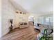 Living room with hardwood floors, neutral paint, vaulted ceilings, and an open-concept design at 458 Moscato Dr, Davenport, FL 33897