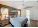 Comfortable main bedroom with a decorative headboard, ceiling fan, and an attached bathroom at 458 Moscato Dr, Davenport, FL 33897