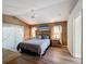 Warm and inviting main bedroom featuring wood floors, vaulted ceilings, and elegant decor at 458 Moscato Dr, Davenport, FL 33897
