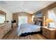 Well-lit main bedroom boasting wood floors, vaulted ceilings, and a cozy ambiance at 458 Moscato Dr, Davenport, FL 33897