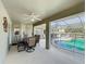 View of the spacious screened patio with dining table, ceiling fan and a glimpse of the pool at 458 Moscato Dr, Davenport, FL 33897