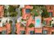 An aerial view displays terracotta rooftops, shared pool, and mature landscaping within the property's surroundings at 5015 Nassau Cir # 4, Orlando, FL 32808