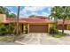 Charming single-story home with a terracotta roof, lush landscaping, and a two-car garage at 5015 Nassau Cir # 4, Orlando, FL 32808