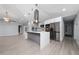 Open concept kitchen with a waterfall island, stainless steel appliances, and modern light fixtures at 5015 Nassau Cir # 4, Orlando, FL 32808