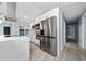 Modern kitchen with white cabinetry, stainless steel appliances, quartz countertops, and tile backsplash at 5015 Nassau Cir # 4, Orlando, FL 32808