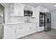 Modern kitchen features white cabinetry, stainless steel appliances, and a stylish marble backsplash at 5015 Nassau Cir # 4, Orlando, FL 32808