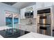 Updated kitchen with stainless steel appliances, white cabinets, and access to a screened in patio and pool at 5015 Nassau Cir # 4, Orlando, FL 32808