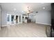 Bright open space featuring wood-look flooring, view into kitchen, and access to the outdoors at 5015 Nassau Cir # 4, Orlando, FL 32808