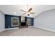 Bright living room featuring a cozy fireplace, large windows, and vaulted ceilings at 5015 Nassau Cir # 4, Orlando, FL 32808